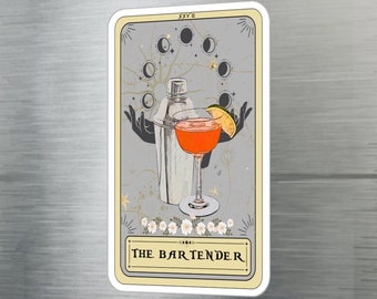 May include: A tarot card with a gray background and gold accents. The card depicts a cocktail shaker and a cocktail glass with a lime wedge. The card is titled "The Bartender" and has the Roman numeral "XXV" in the top right corner.