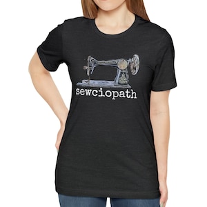 May include: A black t-shirt with a vintage sewing machine graphic and the text "sewciophat" in white.