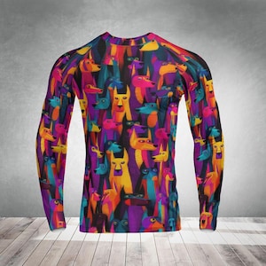 May include: A long-sleeved shirt featuring a vibrant, colorful pattern of stylized dog faces. The design incorporates a variety of hues, including purple, yellow, orange, and blue. The shirt has a crew neck and a fitted silhouette, suitable for casual wear.