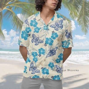May include: Cream-colored short-sleeve button-down shirt with a blue moth and flower pattern. The shirt features a classic collar and is made of a lightweight fabric, perfect for warm weather. The design includes blue hibiscus flowers and moths.