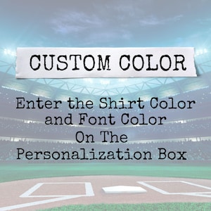 May include: Image with text that reads "CUSTOM COLOR". Below the text, it says "Enter the Shirt Color and Font Color On The Personalization Box". The background is a baseball field.