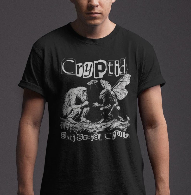 May include: Black t-shirt with a white graphic print of a cryptid, a mythical creature, with the text "Cryptid Anti-Social Club".