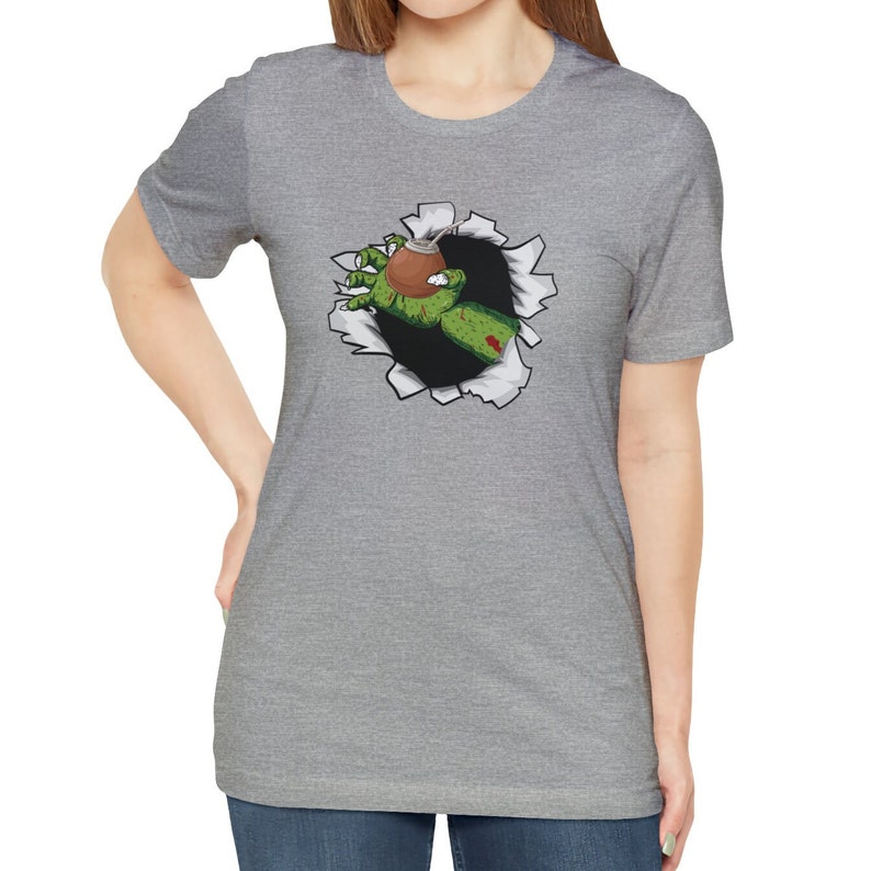 May include: A gray t-shirt with a graphic of a green zombie hand reaching out of a ripped hole, holding a brown gourd.