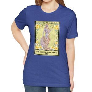 May include: A royal blue t-shirt with a tarot card design featuring a goddess figure with flowers and the text "XIV THE GODDESS OF LOVE".