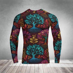 May include: A long-sleeved shirt with a colourful tree design. The pattern showcases trees with blue, purple, orange, and gold foliage on a dark burgundy backdrop. The shirt is a close-fitting style, suitable for layering or wearing on its own.