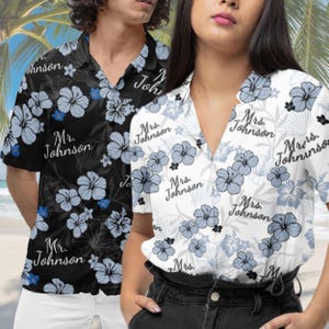 May include: A couple's matching Hawaiian shirts with a floral pattern. The shirts are black and white with blue flowers and the text "Mr. Johnson" and "Mrs. Johnson" repeated on the fabric.