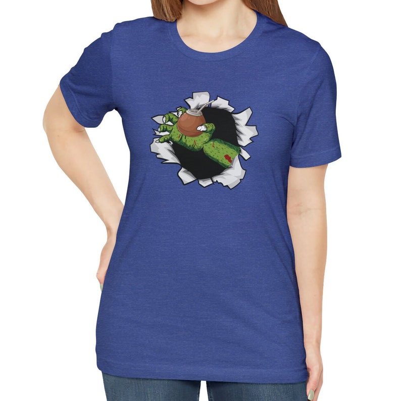 May include: A blue t-shirt with a graphic of a green zombie hand reaching out of a ripped hole, holding a brown gourd.