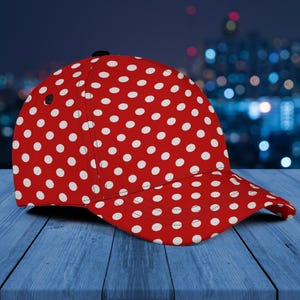 May include: A red baseball cap with a white polka dot pattern.