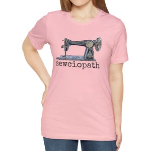 May include: A pink t-shirt with a vintage sewing machine graphic and the text "sewcioptah" printed on the front.