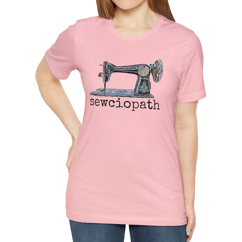 May include: A pink t-shirt with a vintage sewing machine graphic and the text "sewcioptah" printed on the front.