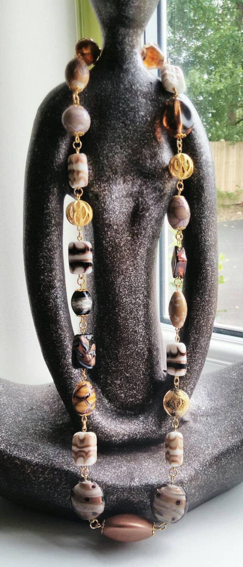 Neutral beaded necklace made with a variety of quality beads