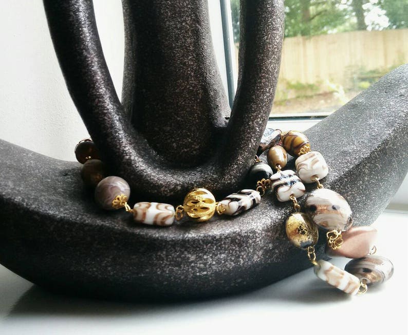 Neutral beaded necklace made with a variety of quality beads