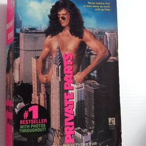 May include: A paperback book titled "Private Parts" by Howard Stern. The cover features Stern with sunglasses, standing in front of a cityscape. The book is a #1 bestseller with photos throughout. The cover also mentions a major motion picture.
