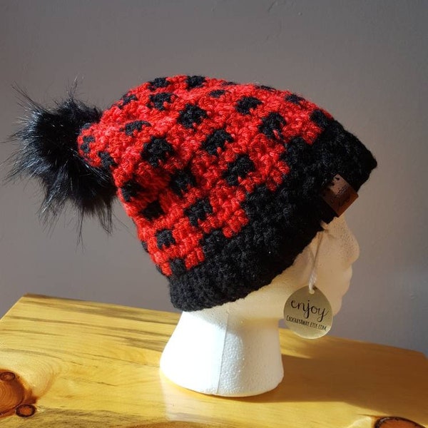 Red and black Plaid slouch hat with faux fur pompom. Size teenage to adult.