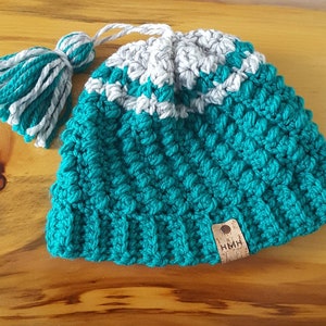 Thick and warm gray and teal hat with tassle. Fits teen to adult.