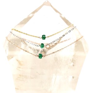 A Green Emerald bracelet features a faceted real Green Emerald that is centered on a 7" cable link SILVER or GOLD-FILLED dainty cable link chain. 
Bring flair to your style, wear it alone or layer it with chains from our collection.