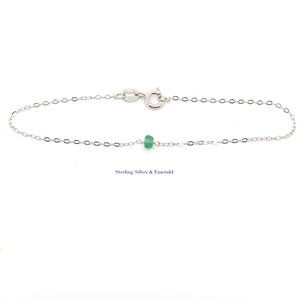A Green Emerald bracelet features a faceted real Green Emerald that is centered on a 7" cable link SILVER or GOLD-FILLED dainty cable link chain. 
Bring flair to your style, wear it alone or layer it with chains from our collection.