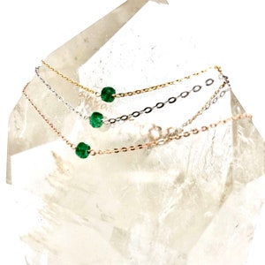 A Green Emerald bracelet features a faceted real Green Emerald that is centered on a 7" cable link SILVER or GOLD-FILLED dainty cable link chain. 
Bring flair to your style, wear it alone or layer it with chains from our collection.