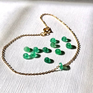 A Green Emerald bracelet features a faceted real Green Emerald that is centered on a 7" cable link SILVER or GOLD-FILLED dainty cable link chain. 
Bring flair to your style, wear it alone or layer it with chains from our collection.