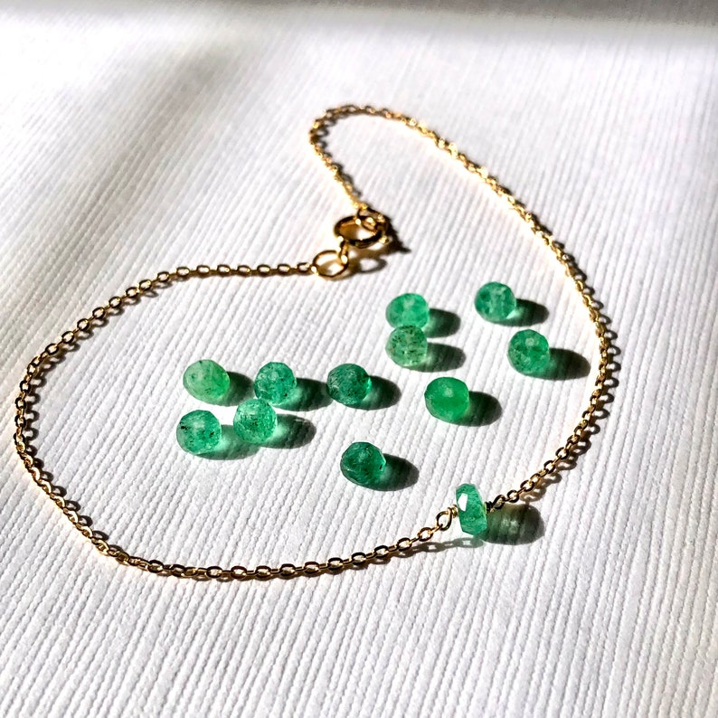 A Green Emerald bracelet features a faceted real Green Emerald that is centered on a 7" cable link SILVER or GOLD-FILLED dainty cable link chain. 
Bring flair to your style, wear it alone or layer it with chains from our collection.