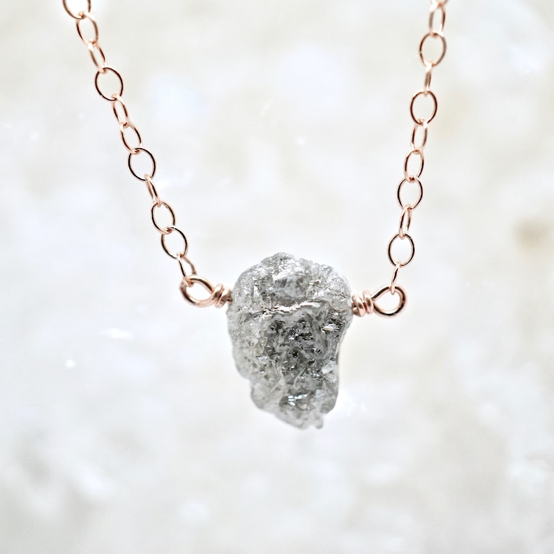 A natural raw diamond centered on a silver or gold chain.  Featured on Buzzfeed.  Conflict-free, hand-made by Jewelluxe