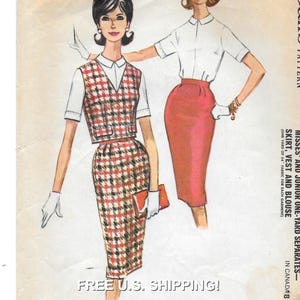May include: A vintage sewing pattern for a skirt, vest and blouse. The pattern is illustrated with a woman wearing a red and black plaid skirt and vest, and a white blouse. The pattern is labelled "Misses and Junior One-Yard Separates - Skirt, Vest and Blouse".