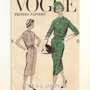 May include: Vintage Vogue printed pattern cover with illustrations of women's dresses. The cover features the word "VOGUE" in large black letters, with "PRINTED PATTERN" below. The illustrations show women in dresses and accessories, showcasing vintage fashion.
