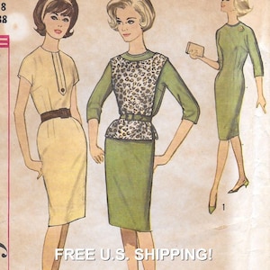 May include: A vintage sewing pattern illustration featuring three dress designs. One dress is light yellow with a brown belt, another is a green dress with a leopard print bodice and belt, and the third is a solid green dress with three-quarter sleeves.