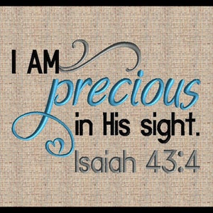 May include: A beige canvas background with a black and blue embroidered quote that reads "I AM precious in His sight. Isaiah 43:4".
