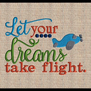 May include: Embroidered design with the text "Let your dreams take flight." The text is in blue, green, and red, with a small blue airplane. The background is a tan woven fabric.