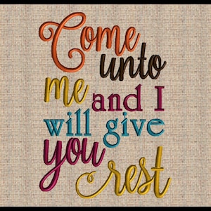 May include: Embroidered quote on a beige fabric background. The quote reads "Come unto me and I will give you rest" in colorful cursive lettering.