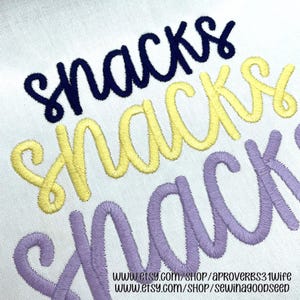 May include: Close-up of embroidered word "Snacks" in navy blue, yellow, and lavender thread on white fabric. The word is written in a cursive script. The image includes two website addresses at the bottom.