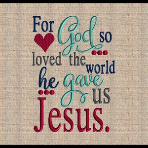 May include: Embroidered design on a beige fabric background. The text reads "For God so loved the world he gave us Jesus." The word "God" is in a cursive font and the word "Jesus" is in a bold font. A red heart is above the word "God".