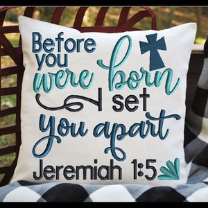 May include: White pillow with blue and black embroidery. The text reads "Before you were born I set you apart Jeremiah 1:5".