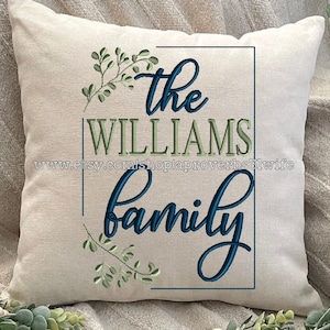 May include: A white pillow with green and blue embroidery that reads "the WILLIAMS family".