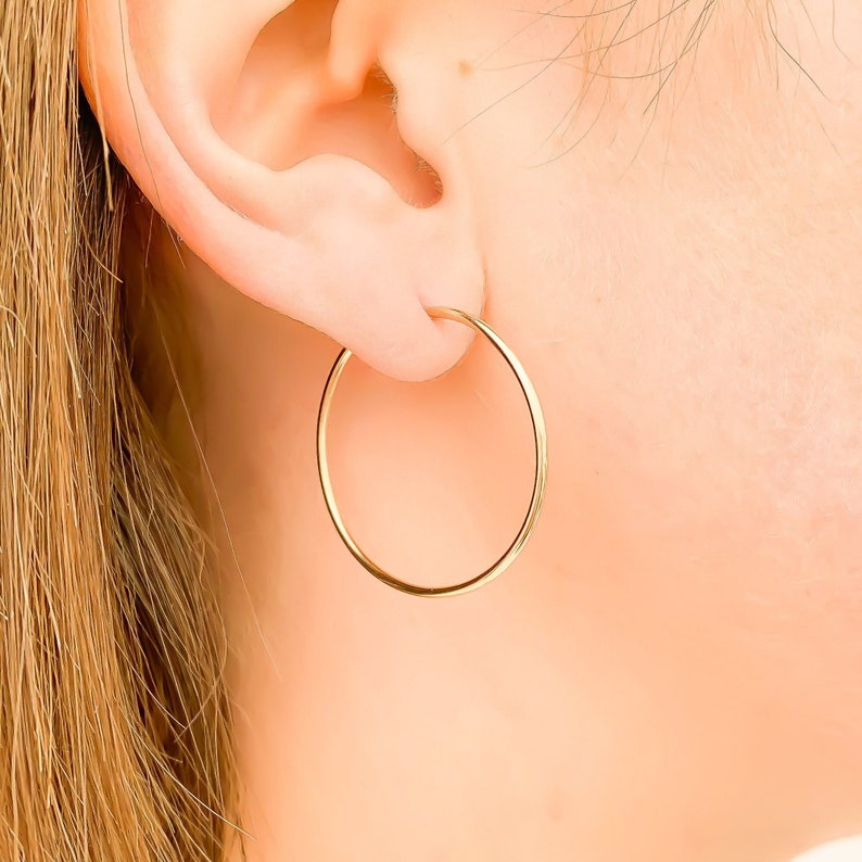 May include: Gold hoop earrings. The earrings are simple and elegant, and they would be a great addition to any jewelry collection.