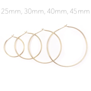 May include: Four gold hoop earrings of different sizes, measuring 25mm, 30mm, 40mm, and 45mm.