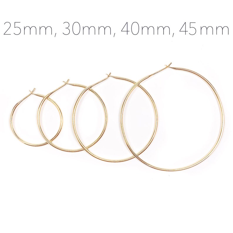 May include: Four gold hoop earrings of different sizes, measuring 25mm, 30mm, 40mm, and 45mm.