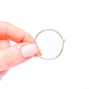 May include: A pair of gold hoop earrings. The earrings are simple and elegant, and they would be a great addition to any jewelry collection.