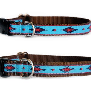 May include: Two dog collars. The collars have a brown base with a turquoise band featuring a red and black geometric pattern. Each collar has a black plastic buckle and a silver metal D-ring.