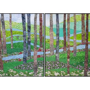 May include: A colorful quilt depicting a forest scene with a winding blue stream, green trees, and a variety of flowers in shades of pink, purple, and white.