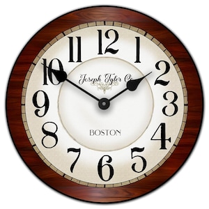 May include: Round wall clock with a dark wood grain frame. The clock face is off-white with black numerals and hands. The text "Joseph Tyler Co." and "BOSTON" are printed on the face.