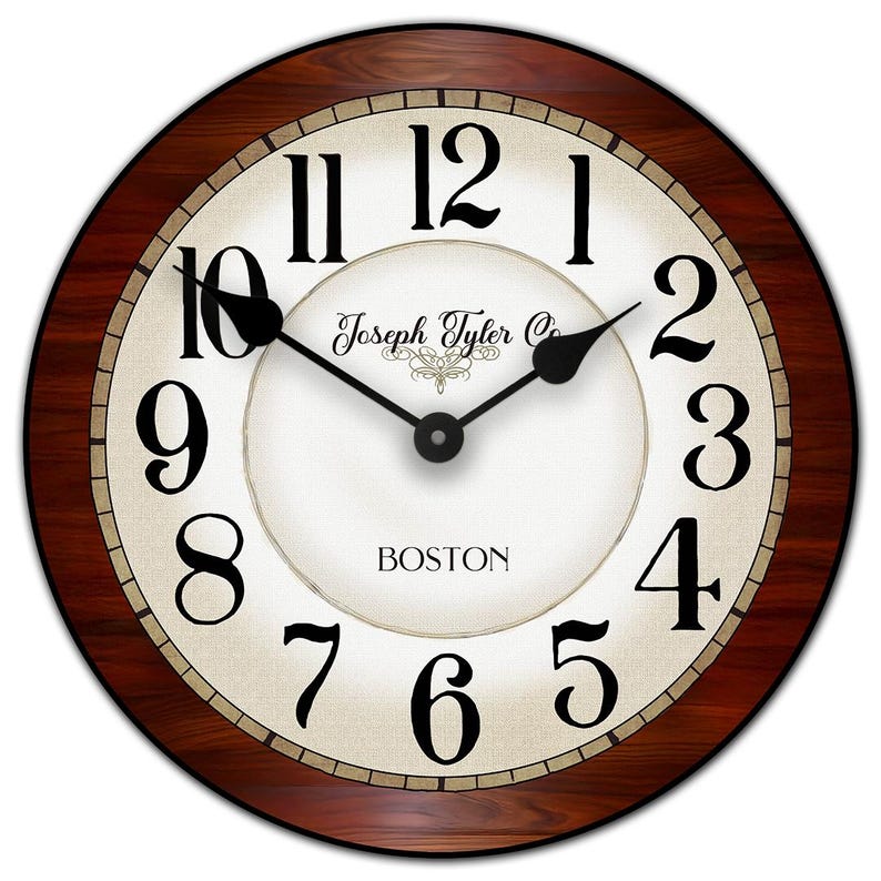 May include: Round wall clock with a dark wood grain frame. The clock face is off-white with black numerals and hands. The text "Joseph Tyler Co." and "BOSTON" are printed on the face.