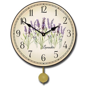 May include: A round, cream-colored pendulum clock with black Roman numeral hour markers and black hands. The clock face features a floral design of lavender flowers and the word "Lavender" in cursive script.