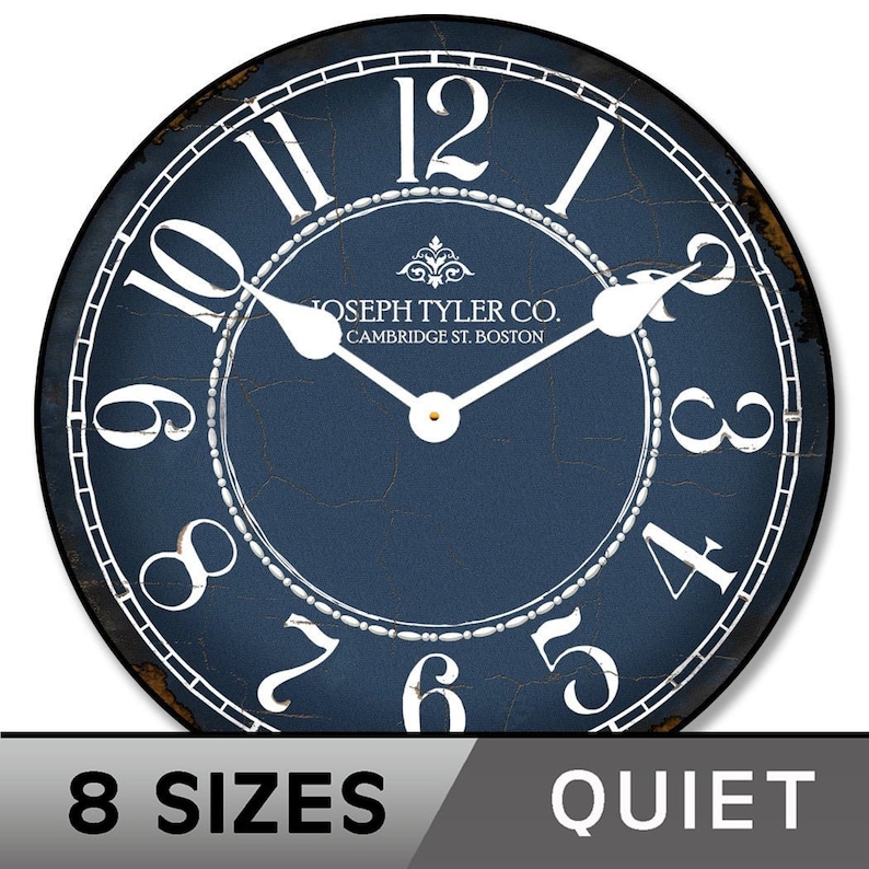 May include: A blue round clock with white Roman numeral markings and a white border. The clock face has a distressed look with visible cracks. The clock face also has the text "JOSEPH TYLER CO. CAMBRIDGE ST. BOSTON".