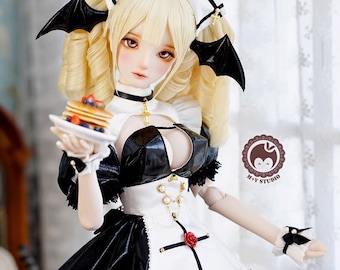 May include: A doll wearing a black and white maid outfit with a black leather bodice, white apron, and black skirt. The doll has blonde hair, a red rose in her hair, and bat wings. The doll is holding a plate with a stack of pancakes and berries.