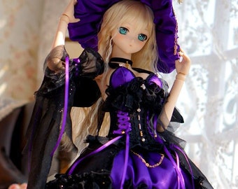 May include: A doll wearing a purple and black witch costume with a large, wide-brimmed hat. The doll has long blonde hair and blue eyes. The doll is standing on a red and white patterned rug.