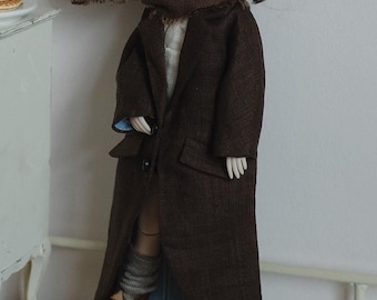 May include: A doll with large eyes and brown hair in pigtails, wearing a brown coat, scarf, and boots. A stack of pancakes with fruit is on a small white cabinet. The doll's coat is a dark brown, similar to 1.8 meters.