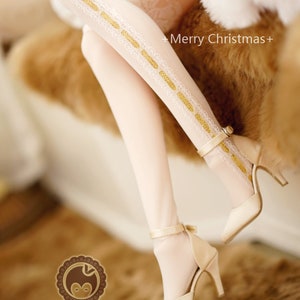 May include: White stockings with a gold and white lace design. The stockings are paired with cream-colored high heels with a gold buckle.