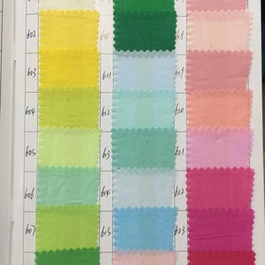 May include: A color chart with 3 columns of fabric swatches. The first column is yellow, green, and light green. The second column is light blue, blue, and pink. The third column is pink, red, and dark red. The swatches are numbered 601-624.
